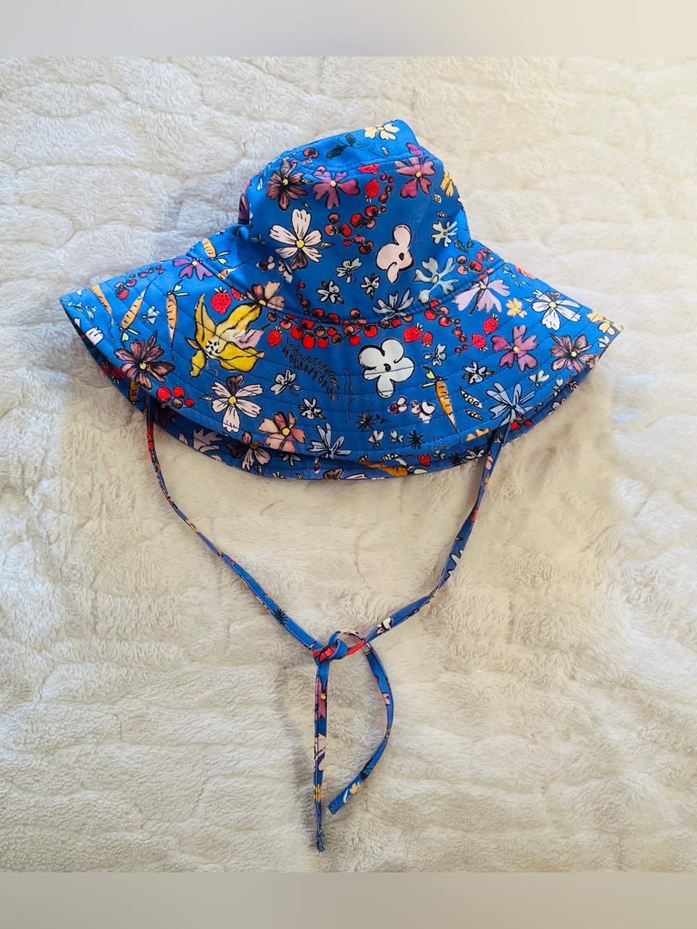 Dauphinette X J.Crew bucket hat featuring a vibrant blue cornucopia floral print